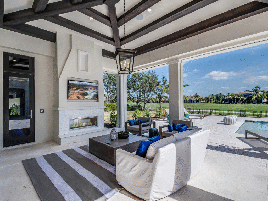 outdoor living space on a patio with built in tv and fire place